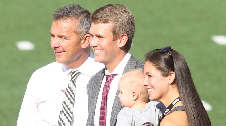 Ohio StateÃs Urban Meyer poses for a photo with son-in-law Corey Dennis, grandson Troy and daughter Nicki Meyer Dennis after arriving at Ohio Stadium before a game against UNLV on Saturday, Sept. 23, 2017, in Columbus. David Jablonski/Staff