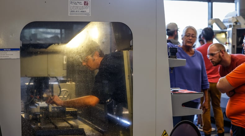 Adam Dixon, left, works in a welding/fabrication shop in Dayton and wants to move up in his shop by taking advanced manufacturing classes at Sinclair Community College. JIM NOELKER/STAFF