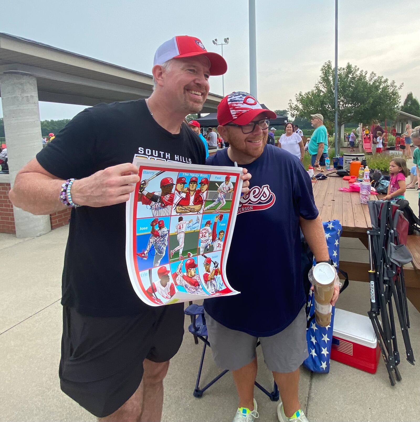 Sean Casey is the last autograph this Cincinnati Reds fan needed on this poster featuring Reds Legends of the ‘90s. Casey was at Joe Nuxhall Miracle League Fields on Saturday, July 23, 2022, with a group of players from his Miracle League of the South Hills in Pittsburgh. MICHAEL D. PITMAN/STAFF 