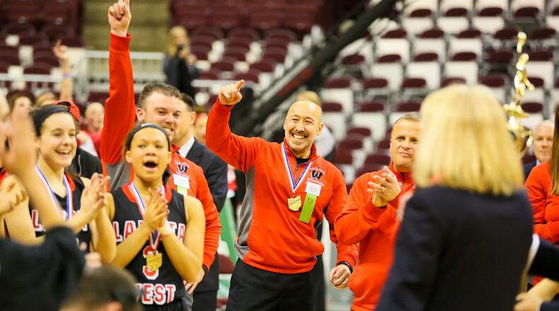 Lakota West girls basketball coach Andy Fishman (center) celebrates with his team after its Division I state championship victory on March 21, 2015, at the Schottenstein Center in Columbus. Lakota West beat Toledo Notre Dame Academy, 44-38. GREG LYNCH/STAFF