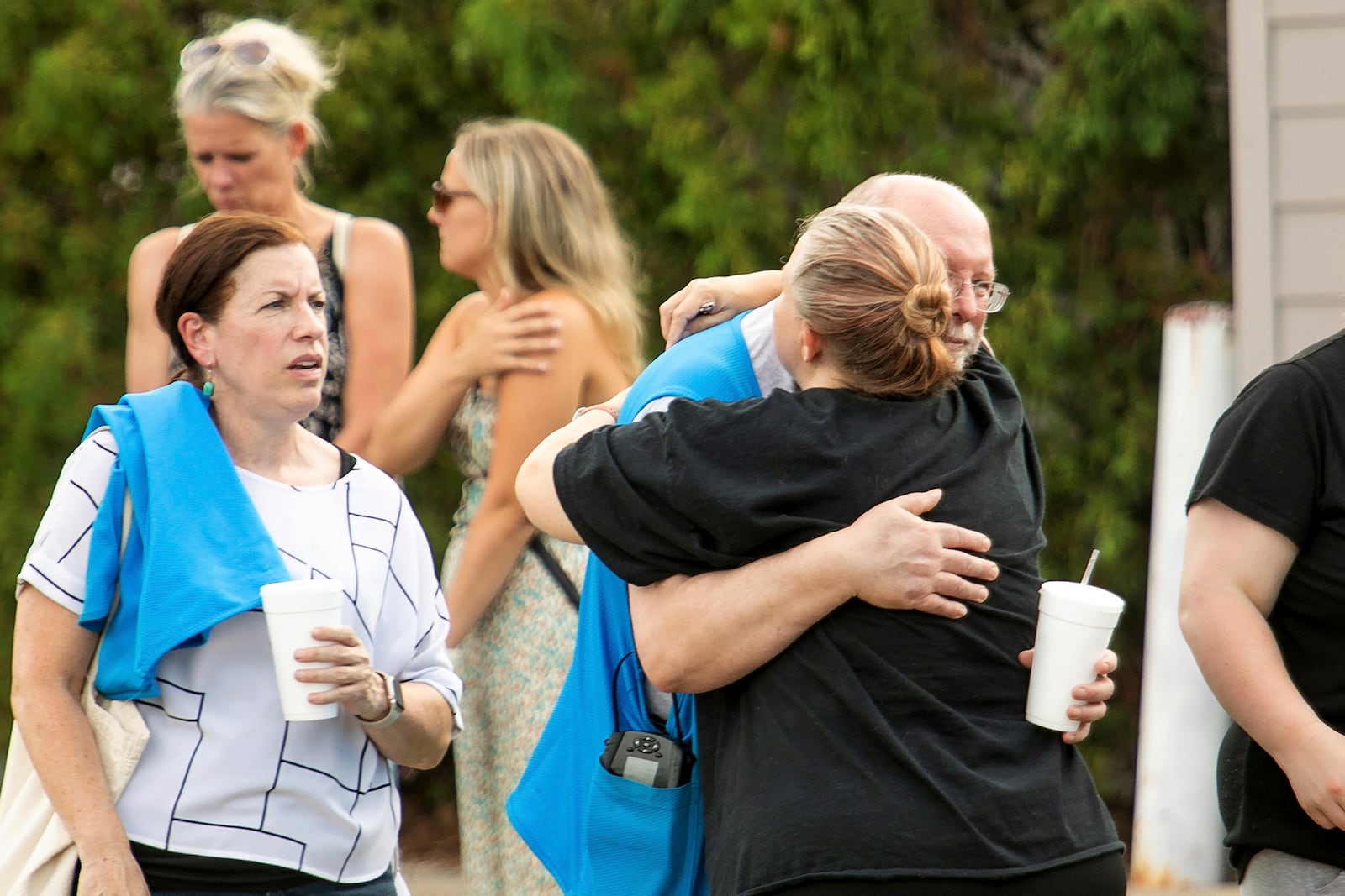 Walmart employees and customers wait outside while law enforcement investigates the scene after a stabbing incident in Traverse City, Mich., Saturday July 26, 2025. (Jan-Michael Stump/Traverse City Record-Eagle via AP)