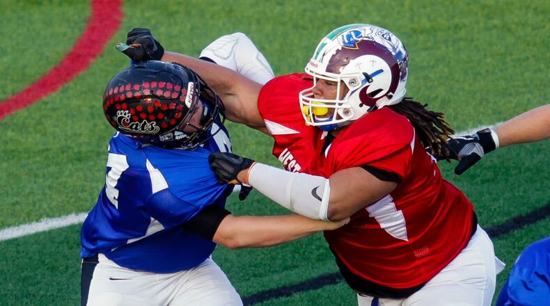 The East’s Nathaneel Rudd (left) of Franklin battles at the line with the West’s Jason Smith of Hamilton on Thursday night during the 43rd Southwestern Ohio Football Coaches Association Ron Woyan East-West All-Star Game at Kings. NICK GRAHAM/STAFF