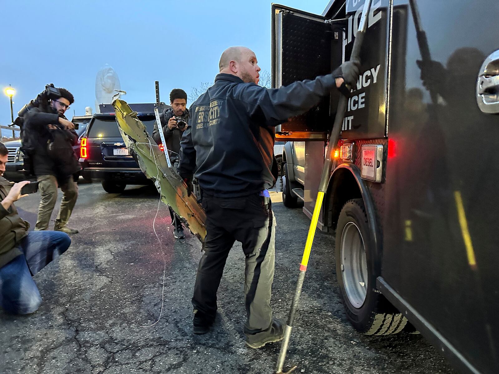 An agent with the Jersey City Office of Emergency Management and Homeland Security loads pieces of wreckage at the scene where a helicopter crashed into the Hudson River, Thursday, April 10, 2025, in Jersey City, N.J. (AP Photo/Ted Shaffrey)