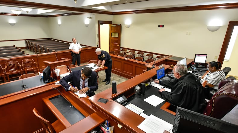 Hamilton Municipal Court Judge Daniel Gattermeyer does his arraignments of people in jail through video using a laptop Friday morning, April 3, 2020 in Hamilton. Hamilton is one of many courts trying to find ways to minimize congestion in the courtrooms to reduce the spread of coronavirus. NICK GRAHAM / STAFF