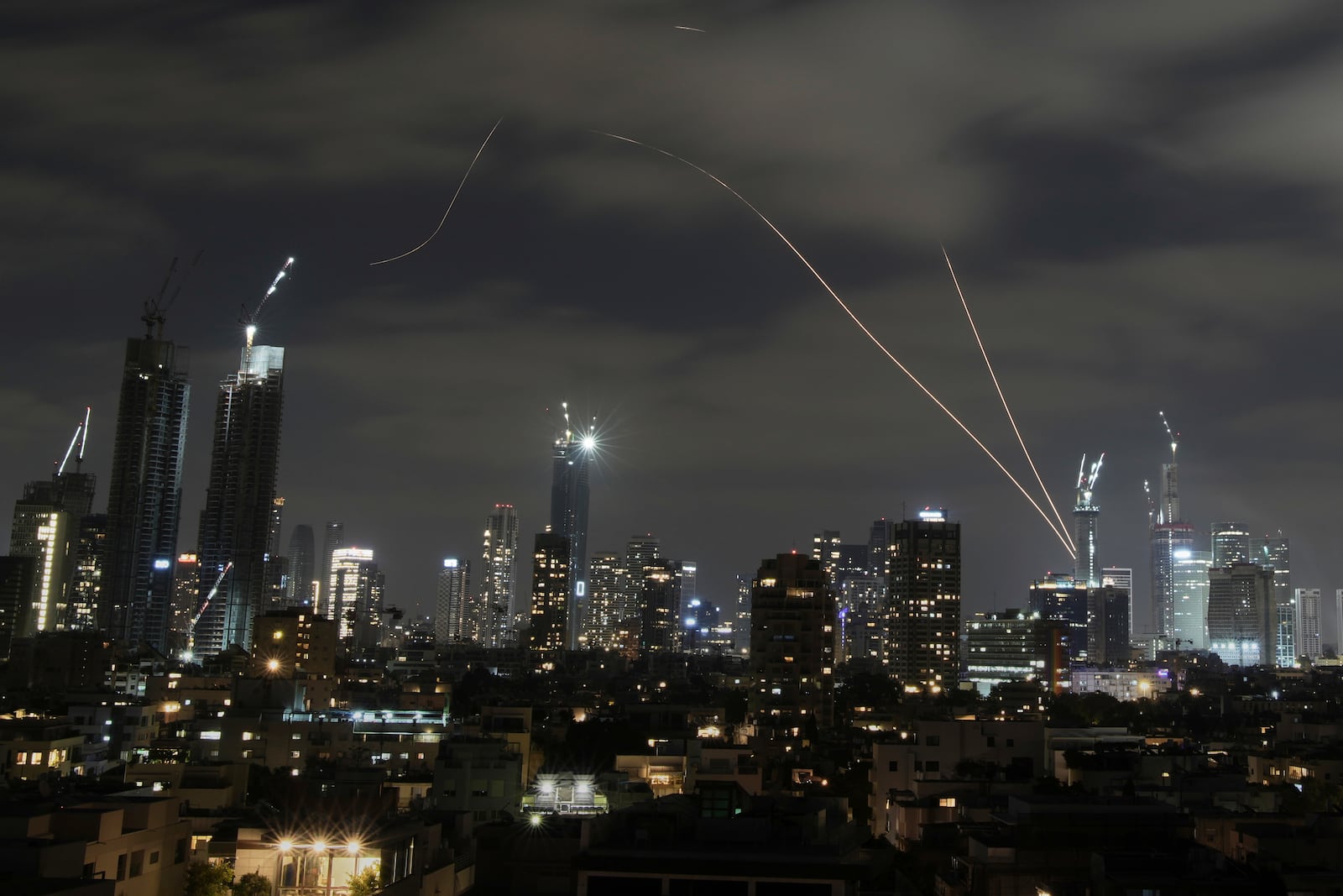 The Israeli Iron Dome air defense system fires to intercept missiles over Tel Aviv, Israel, Sunday, June 15, 2025. (AP Photo/Leo Correa)