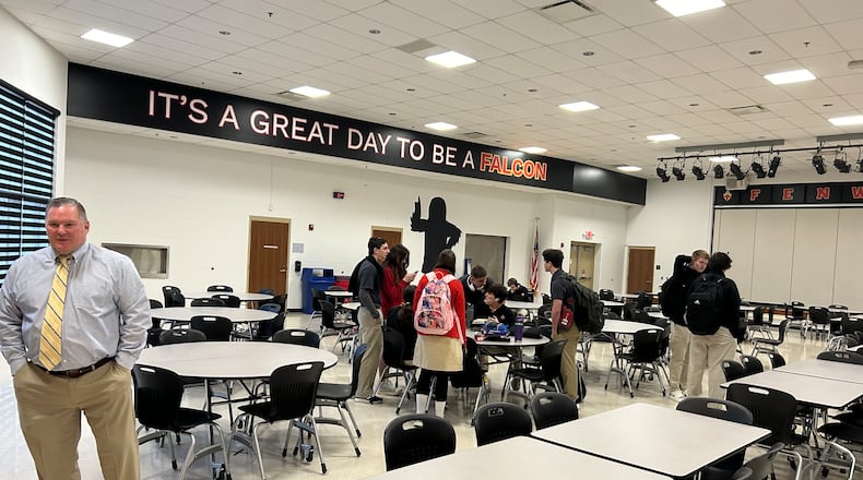 Fenwick High School students were surprised April 2 to see the cafeteria had been painted during Easter Break. Principal Blane Collison, left, says the new look is a “great way to celebrate our school.” RICK MCCRABB/CONTRIBUTED
