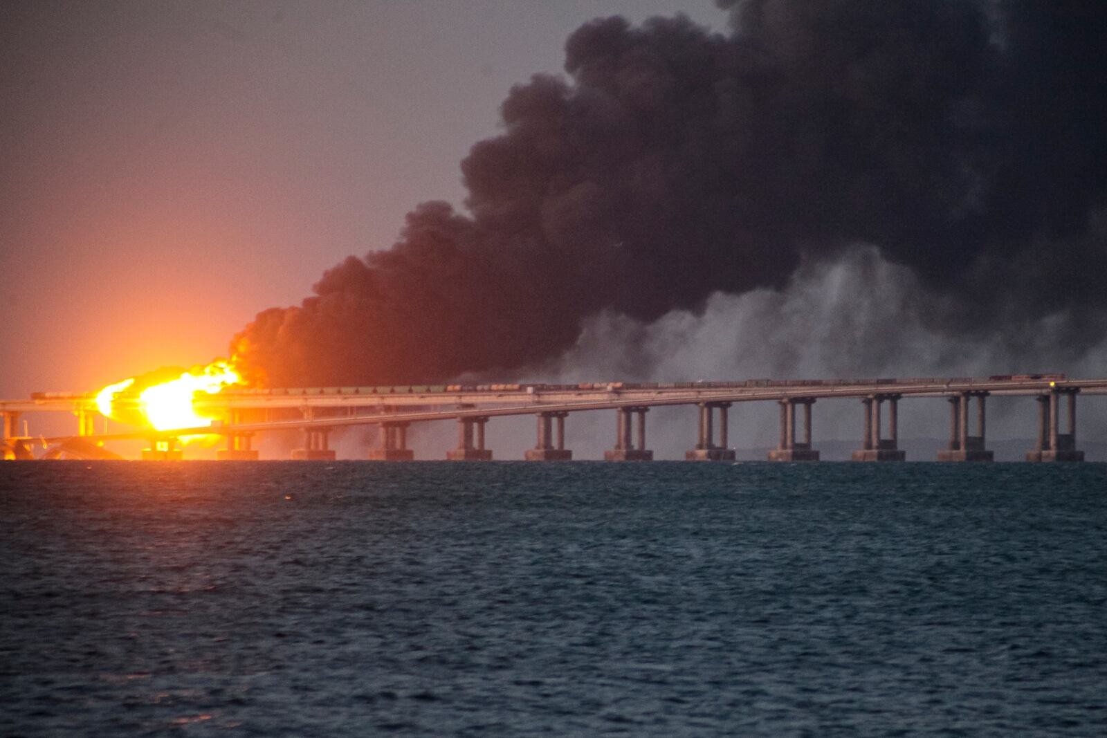 FILE - Flames and smoke rise from a bridge connecting Crimea and Russia in Kerch, on the Crimean peninsula, Oct. 8, 2022. (AP Photo, File)
