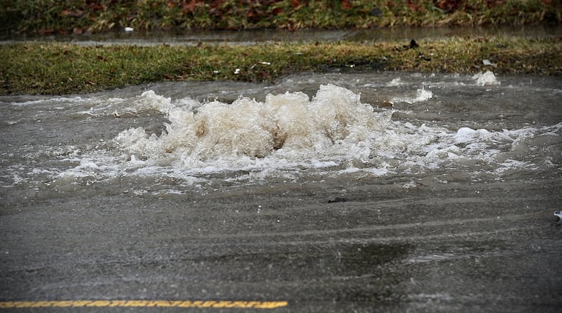 Manhole cover pops up on Nicolas Road in the 3000 block due to heavy rain Tuesday, February 22, 2022. MARSHALL GORBY \STAFF
