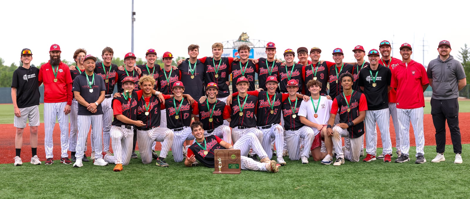Lakota West players and coaches pose for a team photo following a 3-2 win over Cincinnati Moeller in a Division I district final on Wednesday at Wright State University's Nischwtiz Stadium. The program earned its first state berth since 2017 with a 3-2 victory. BRYANT BILLING / STAFF