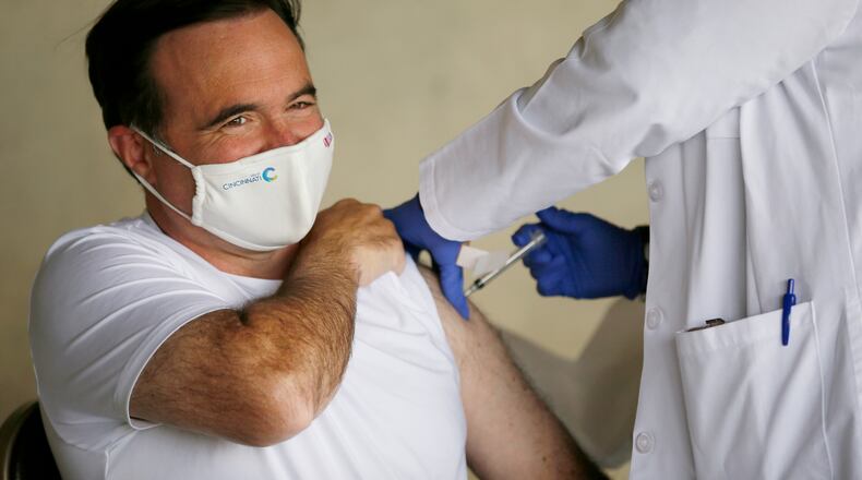 Cincinnati Mayor John Cranley announced Friday that he tested positive for COVID-19. He is fully vaccinated with a booster shot and said he is experiencing only mild symptoms. The two-term mayor and Democratic gubernatorial candidate is shown receiving his second dose of the Moderna COVID-19 vaccine in a shot administered by nursing director Virginia Scott at the Cincinnati Health Department building in the Corryville neighborhood of Cincinnati on April 19, 2021. Cranley encouraged people to seek the vaccine and refrain from politicizing the treatment. (Sam Greene/The Cincinnati Enquirer via AP)