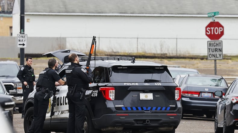 Hamilton Police surrounded a house on North Sixth Street Wednesday looking for a suspect in a shots fired incident on Laurel Avenue. NICK GRAHAM/STAFF