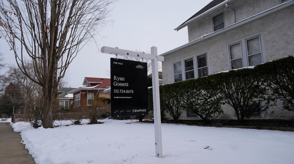 A for sale sign is posted outside a home Monday, Feb. 9, 2026, in Chicago. (AP Photo/Erin Hooley)
