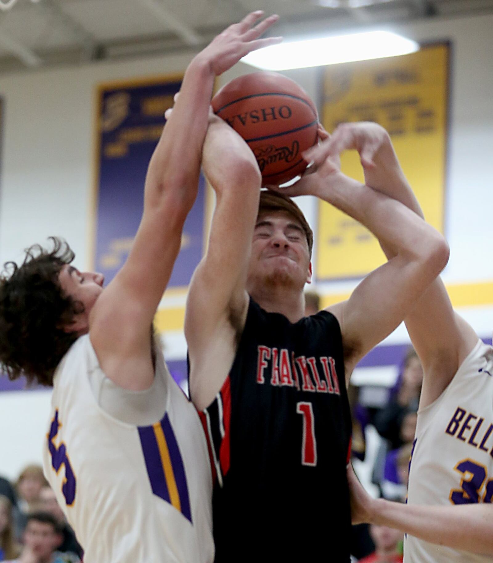 Franklin forward Noah Kremer is pressured by Bellbrook’s Jack Campbell (5) and Caleb Scott (30) during their game at Bellbrook on Friday night. CONTRIBUTED PHOTO BY E.L. HUBBARD