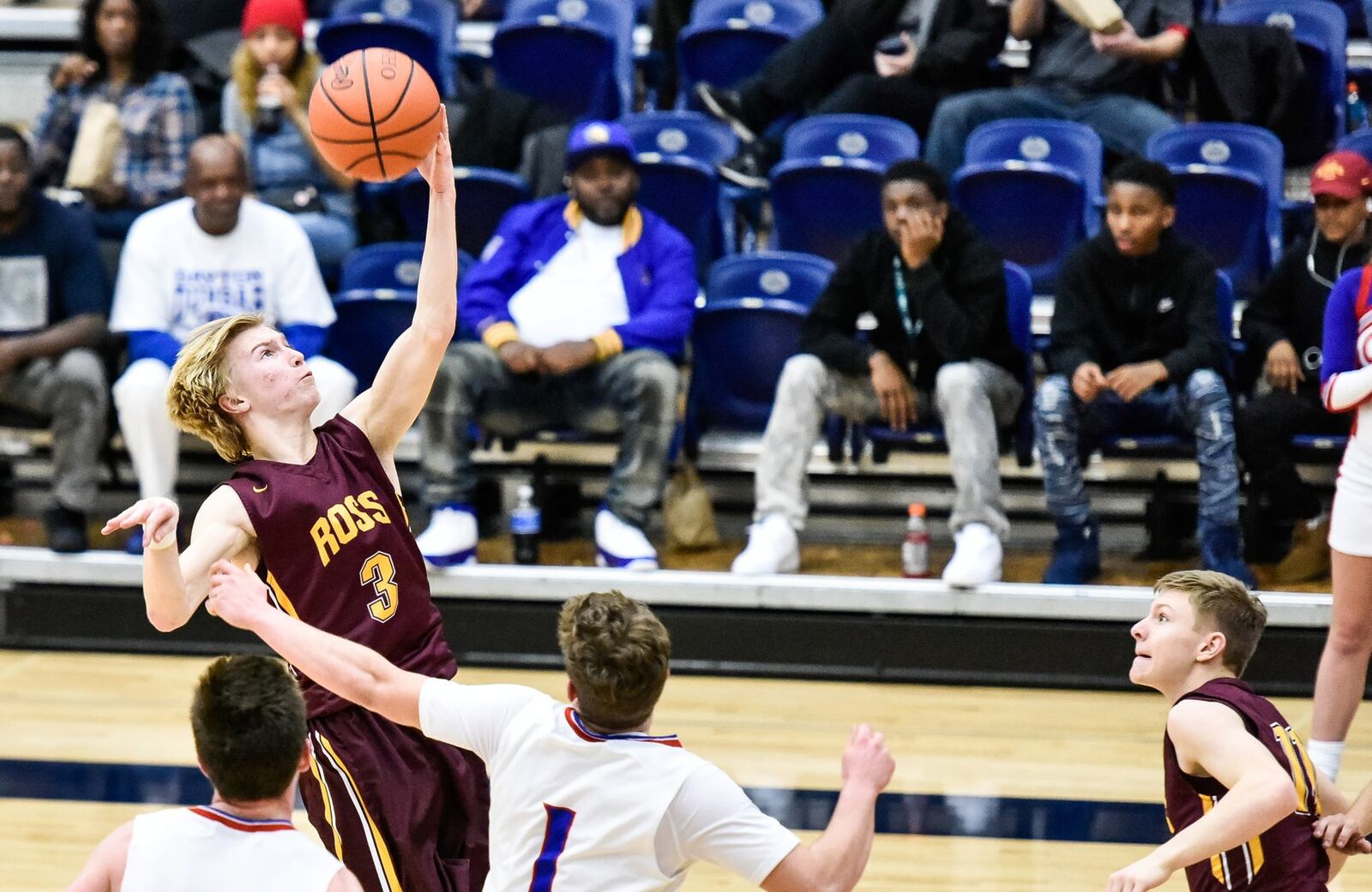 Dylan Zimmerman of Ross grabs a pass over Clinton-Massie’s Daulton Wolfe on Friday during Division II sectional action at Fairmont’s Trent Arena in Kettering. NICK GRAHAM/STAFF