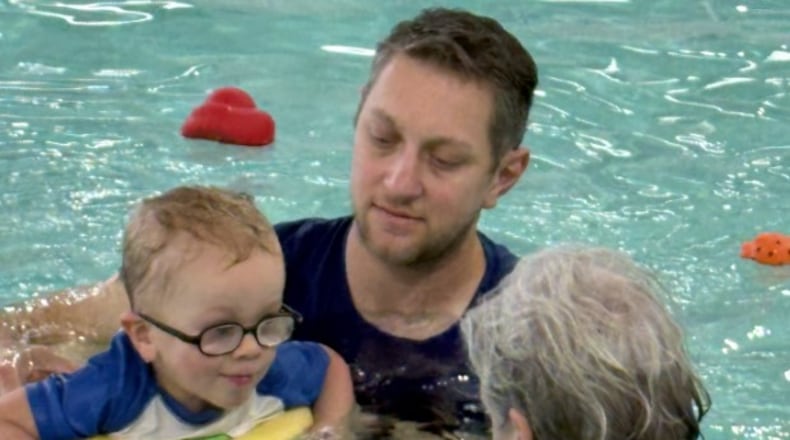 Instructor Becky Swanson works with Theo, 2, and his father, Robert Ghantous, in the Adaptive Safety Around Water Program at the Great Miami Valley YMCA. CONTRIBUTED
