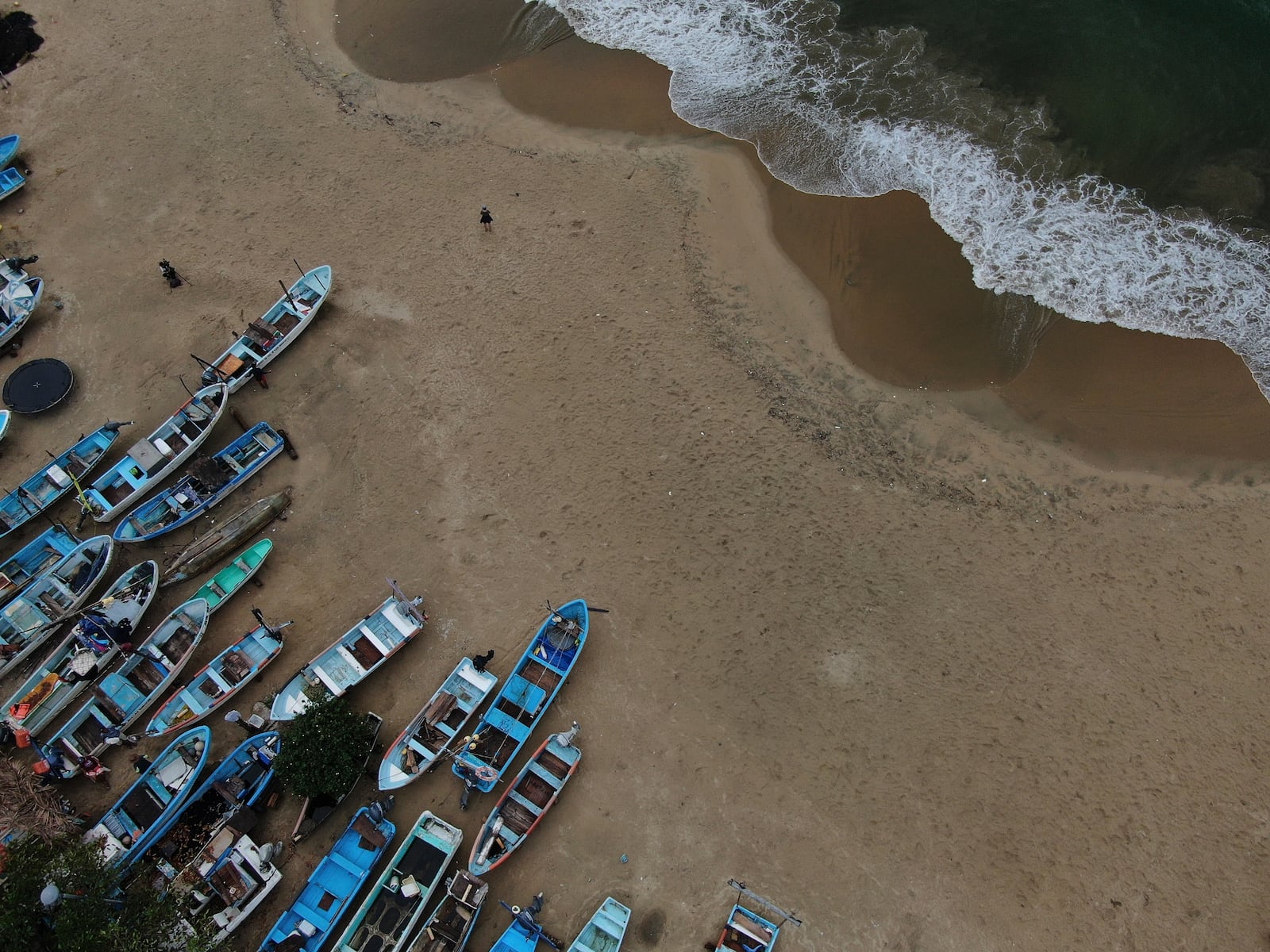 Fishing boats sit on Manzanillo beach for safe keeping after Hurricane Erick hit near Acapulco, Mexico, Thursday, June 19, 2025. (AP Photo/Fernando Llano)
