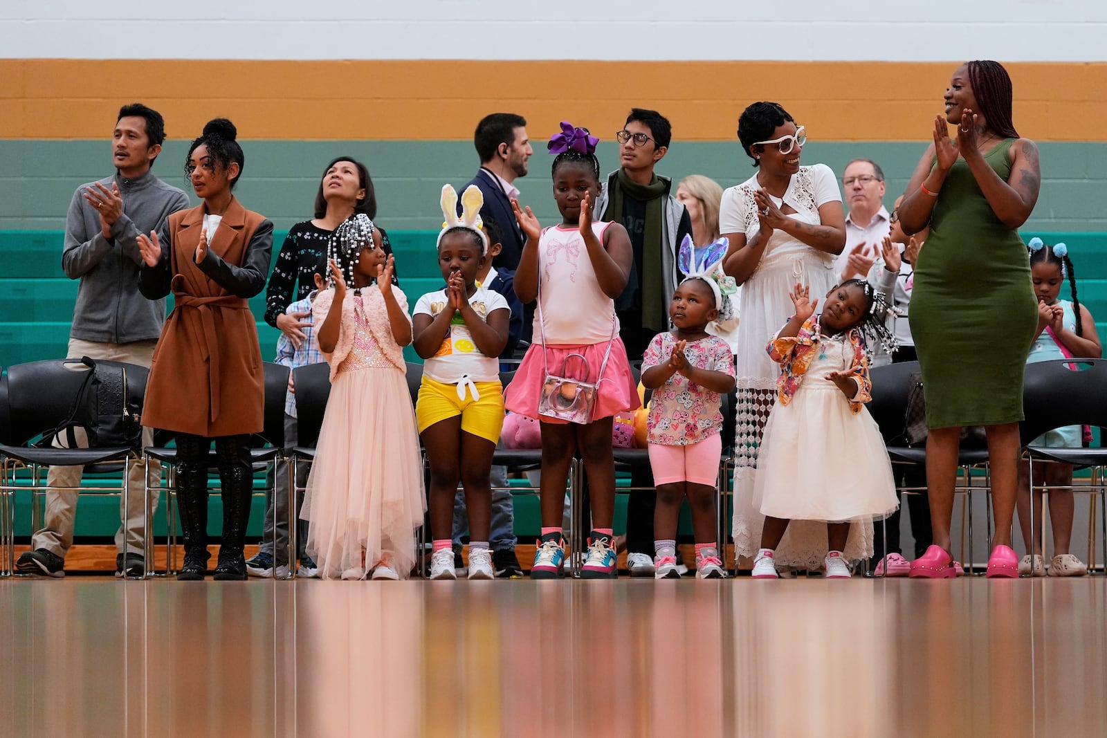 Parishioners stand to worship with Pastor Cory Bowman at River Church Cincinnati's Easter worship service in the Hays Porter Elementary School gym, Sunday, April 20, 2025, in Cincinnati. Cory . (AP Photo/Carolyn Kaster)