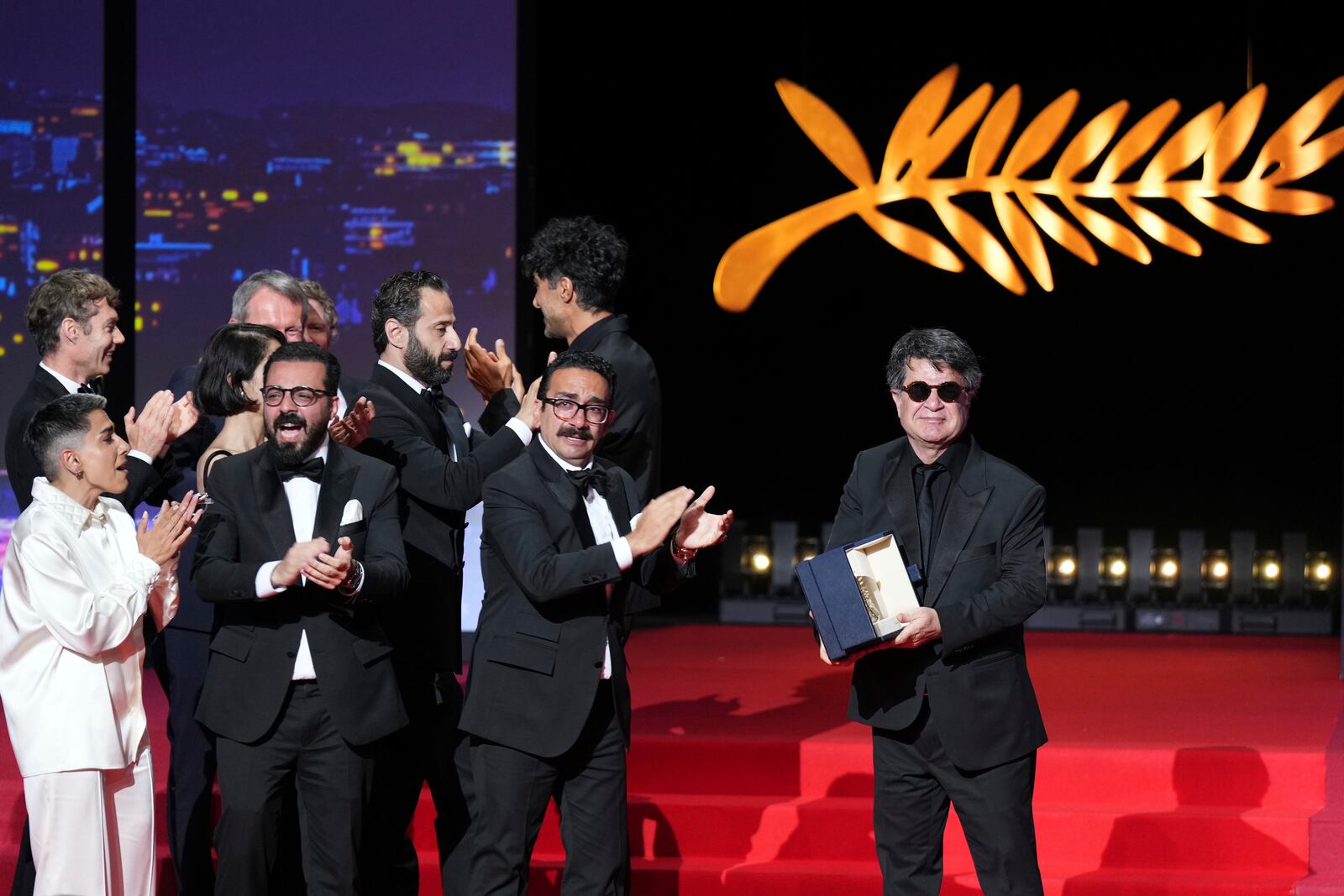 Director Jafar Panahi, right, accepts the Palme d'Or for the film 'It Was Just an Accident', during the awards ceremony of the 78th international film festival, Cannes, southern France, Saturday, May 24, 2025. (Photo by Lewis Joly/Invision/AP)