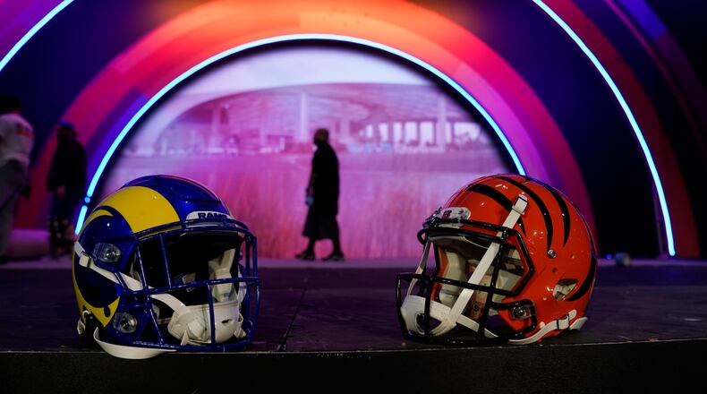 Los Angeles Rams and Cincinnati Bengals helmets rest on a stage inside the NFL Experience, an interactive fan show, Friday, Feb. 4, 2022, at the Los Angeles Convention Center in Los Angeles. The Los Angeles Rams are scheduled to play the Cincinnati Bengals in the Super Bowl NFL football game Feb. 13 in Inglewood, Calif. (AP Photo/Marcio Jose Sanchez)