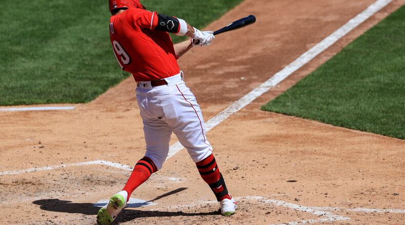 Cincinnati Reds' Joey Votto hits a two-run RBI double during the fifth inning of a baseball game against the Cleveland Indians in Cincinnati, Sunday, April 18, 2021. (AP Photo/Aaron Doster)
