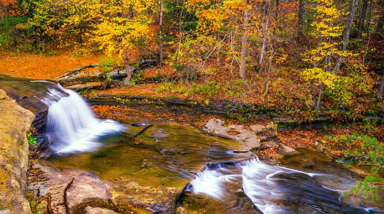 An autumn view of a waterfall in the hardwood foreat at Hocking Hills State Park in Ohio. ISTOCK