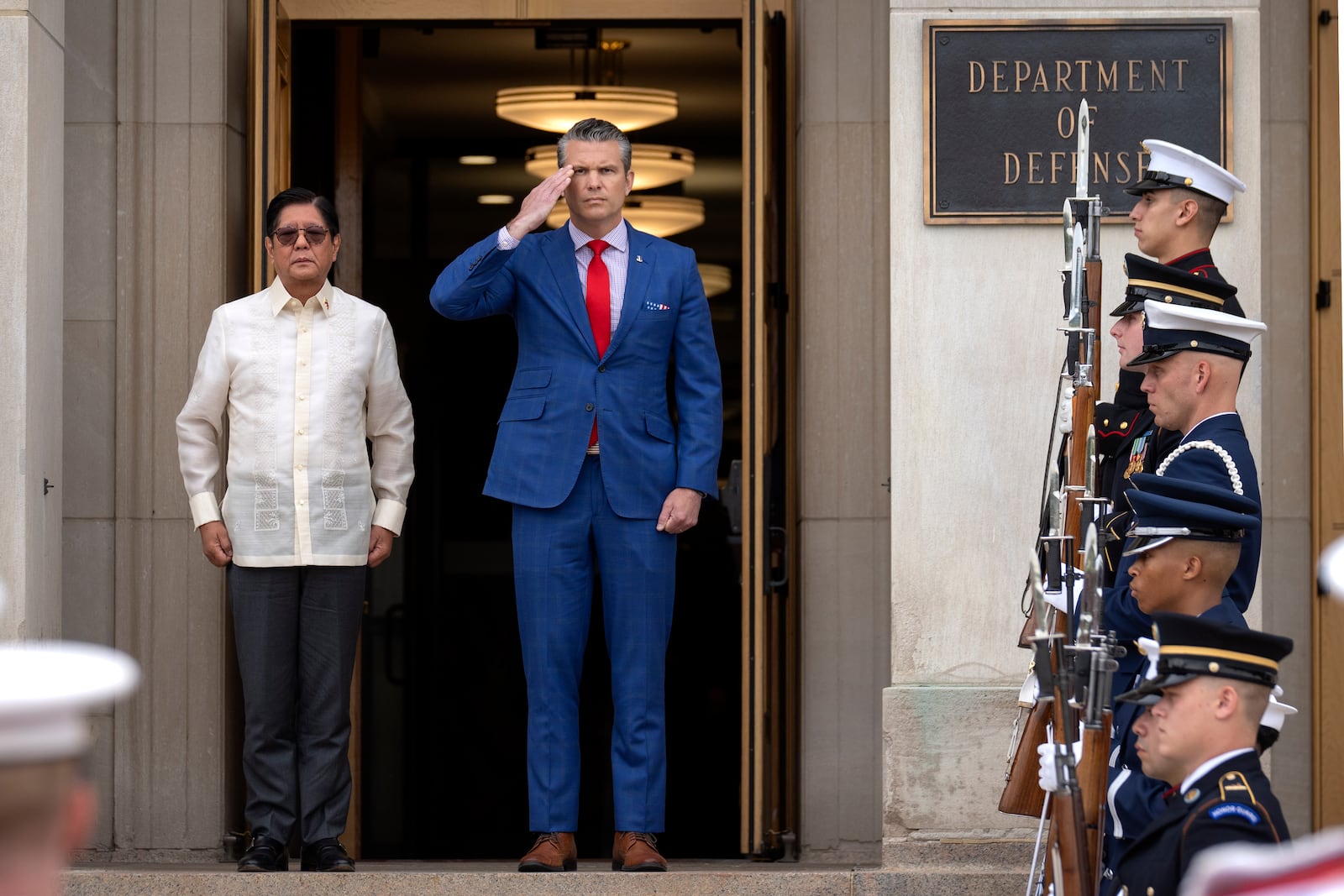 Secretary of Defense Pete Hegseth, right, stands with Philippine President Ferdinand Marcos Jr. during an honor cordon ceremony at the Pentagon, Monday, July 21, 2025, in Washington. (AP Photo/Mark Schiefelbein)