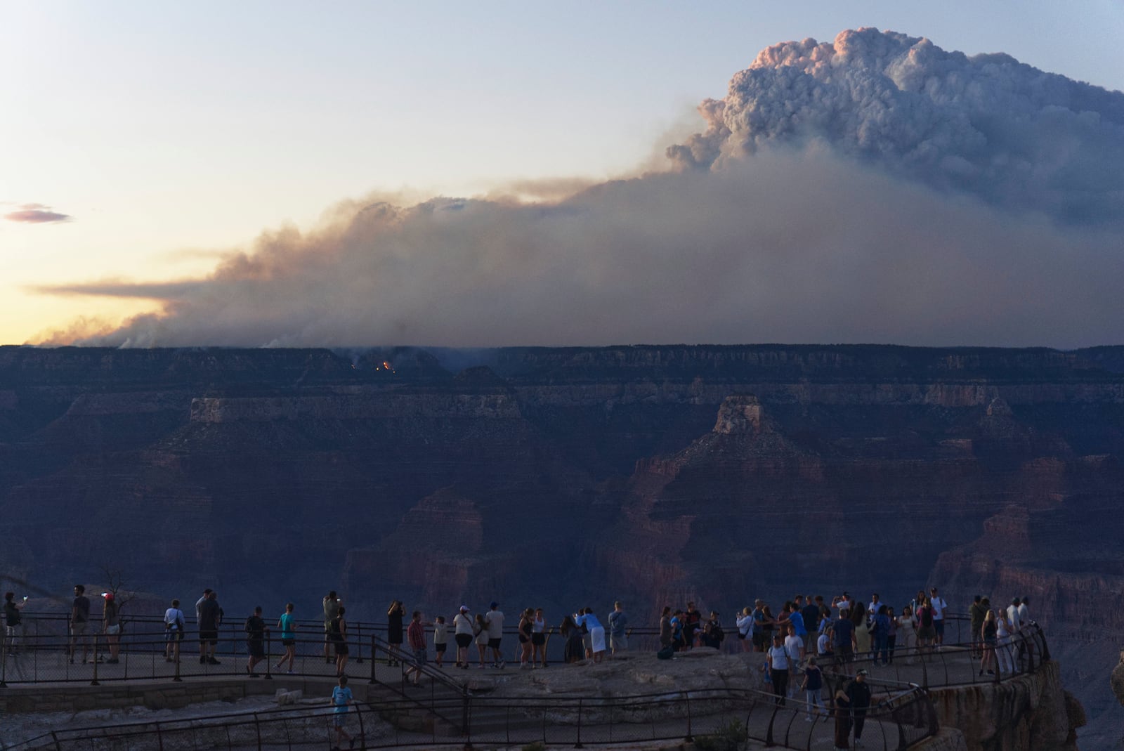 Smoke and a pyrocumulus cloud rises at sunset from the Dragon Bravo fire at the Grand Canyon as seen from Mather Point near Grand Canyon Village, Ariz., Monday, July 28, 2025. (AP Photo/Jon Gambrell)
