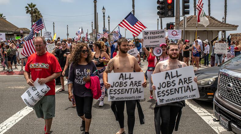 FILE — A demonstration against a lockdown in Huntington Beach, Calif., May 9, 2020. A manifesto, the so-called Great Barrington Declaration, that urges reliance on “herd immunity” without lockdowns was warmly received by White House administration officials, but the strategy cannot stem the pandemic, many experts say. (Bryan Denton/The New York Times)