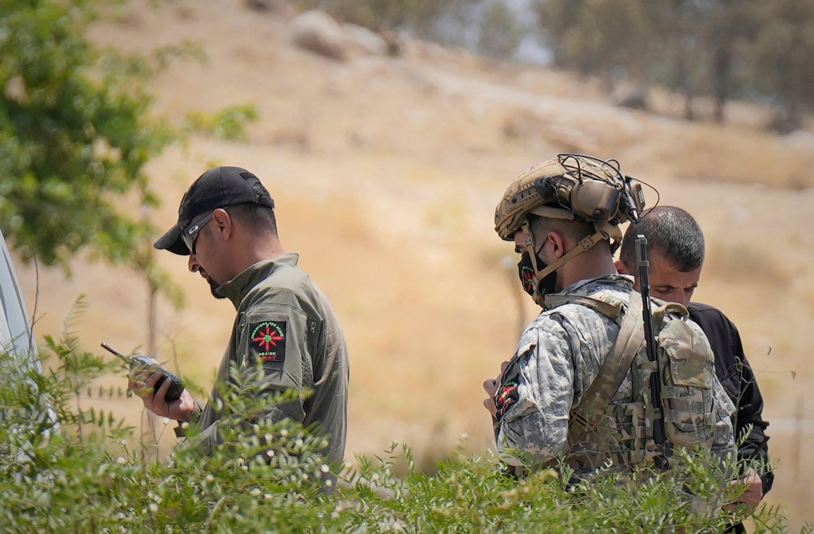 Forces of the regional Kurdish administration secure the area of the Jasana Cave ahead of a symbolic disarmament ceremony by the separatist PKK group as part of the peace process with Turkey, in Sulaymaniyah governorate, Iraq, Friday, July 11, 2025. (AP Photo/Hadi Mizban)