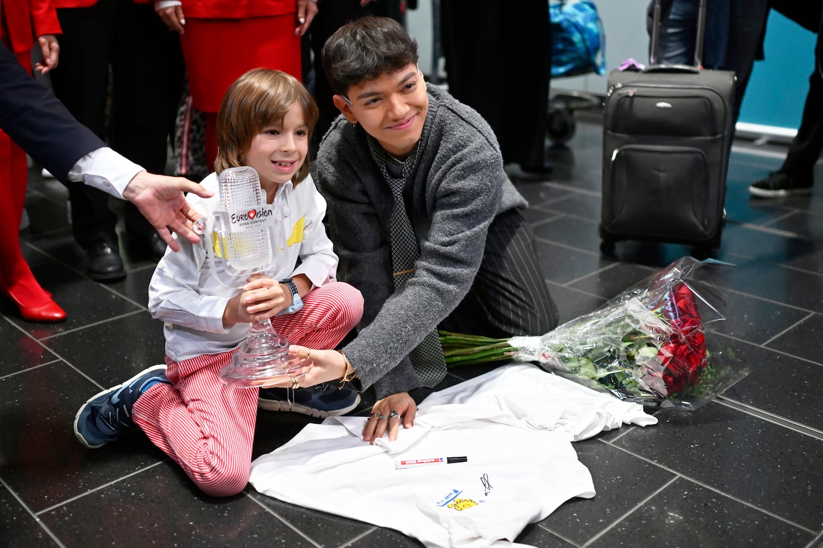 JJ, right, from Austria arrives at the airport in Vienna, Austria, Sunday, May 18, 2025, after winning the Grand Final of the 69th Eurovision Song Contest, in Basel yesterday. (AP Photo/Denes Erdos)