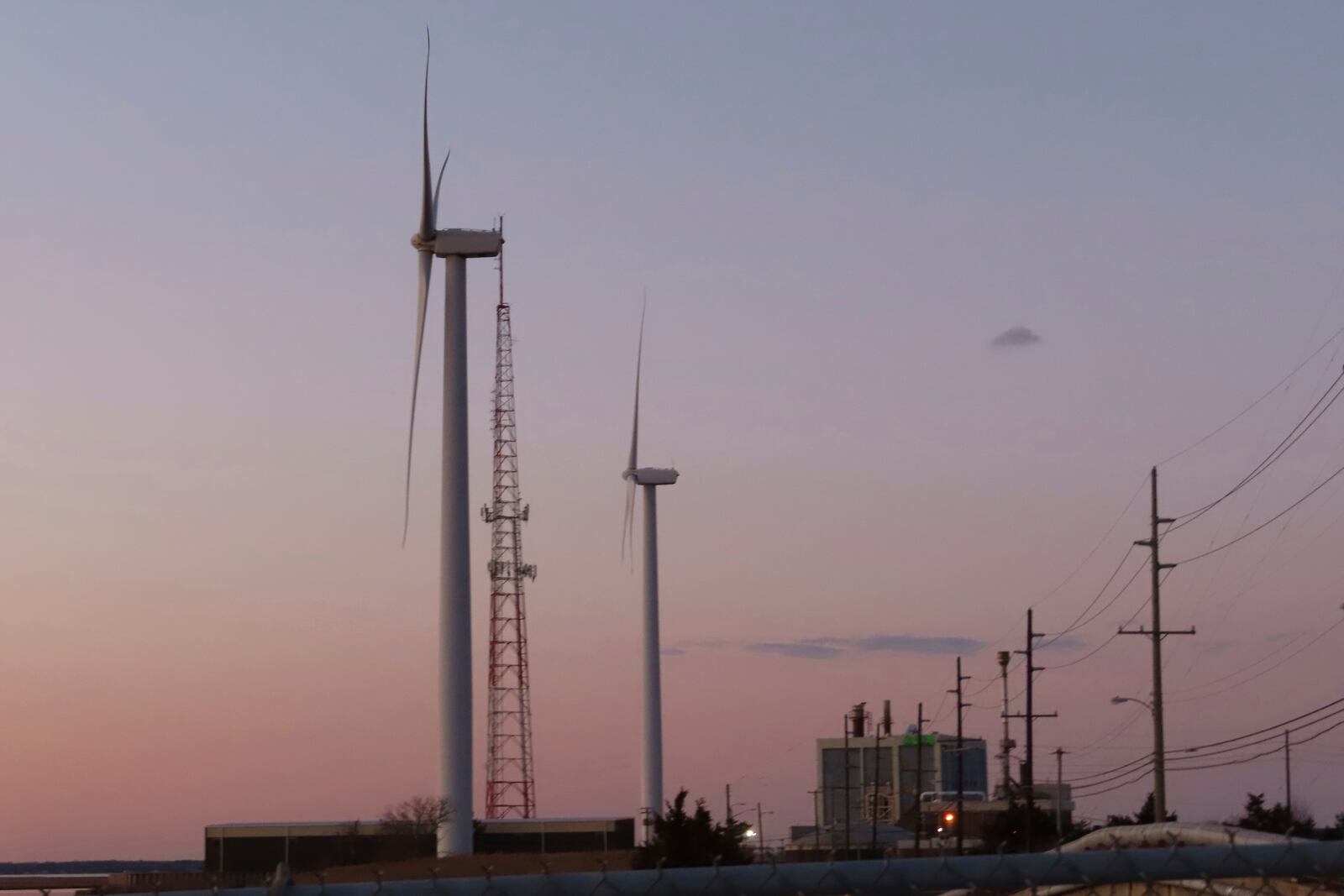 FILE - The sun sets behind a land-based wind farm in Atlantic City, N.J., on Feb. 10, 2022. (AP Photo/Wayne Parry, File)