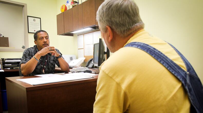 The Butler County Veterans Service Commission is set to pass a $2.3 million tax budget for 2018. Pictured here is Service Officer Willie Croxton helping veteran Michael Garrett in 2014. GREG LYNCH / STAFF