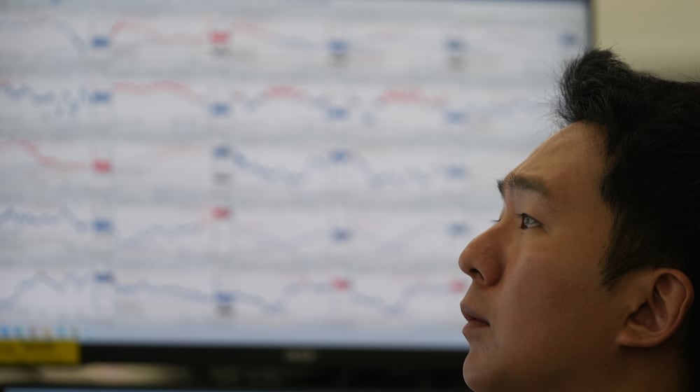 A dealer watches computer monitors at a dealing room of Hana Bank in Seoul, South Korea, Thursday, Dec. 18, 2025. (AP Photo/Lee Jin-man)