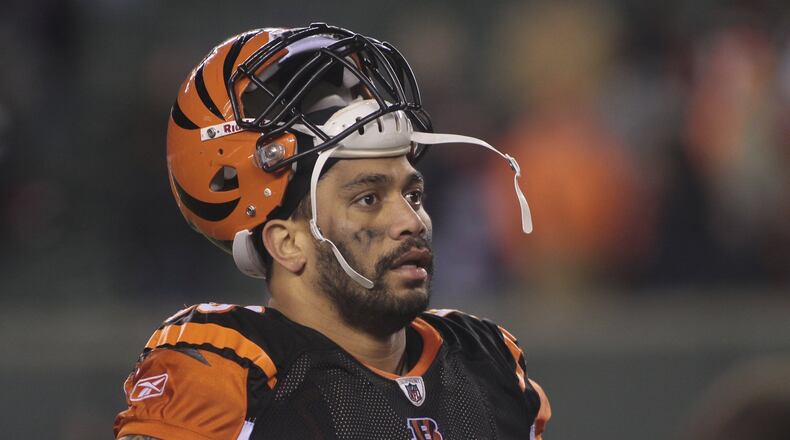 FILE - In this Jan. 1, 2012, file photo, Cincinnati Bengals defensive end Jonathan Fanene walks off the field after an NFL football game against the Baltimore Ravens in Cincinnati. Court filings allege former Cincinnati Bengals defensive end Jonathan Fanene faces charges used a pipe, golf club and broom handle to assault his wife and his sister over allegations he had an extramarital affair while on a trip to Hawaii. Fanene has been charged in the District Court of American Samoa with eight felonies, including kidnapping and assault, and five misdemeanors. He has been released on $100,000 bail and will appear in court next week. (AP Photo/Tony Tribble, File)
