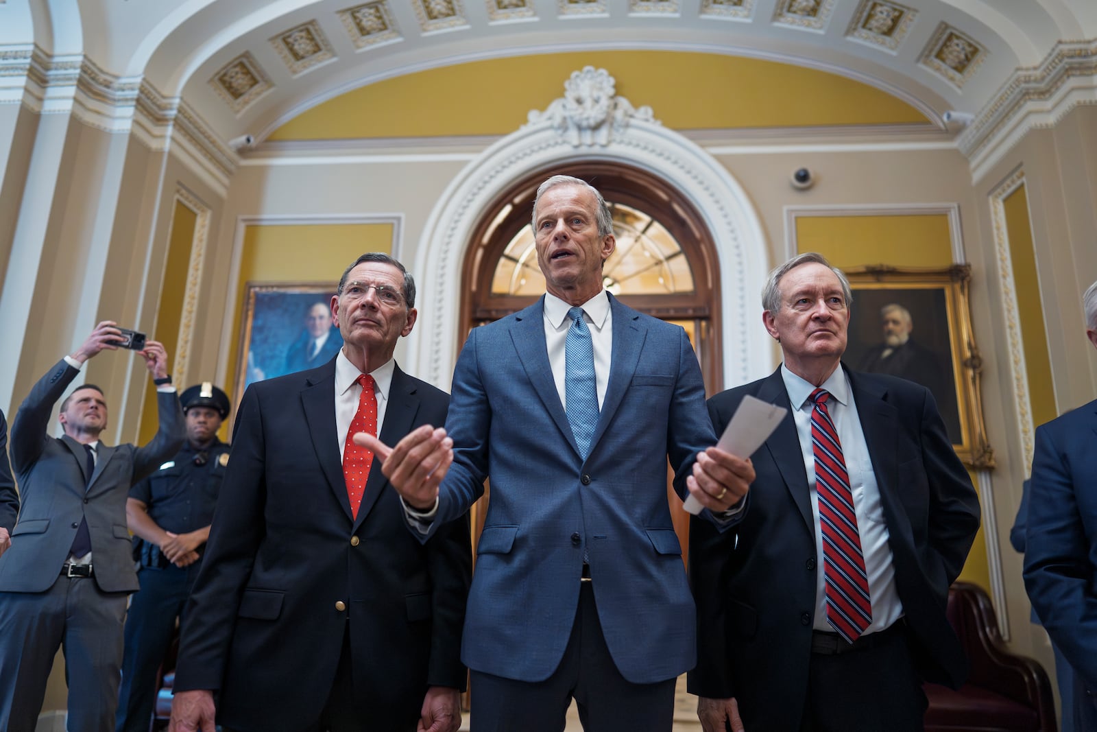 Senate Majority Leader John Thune, R-S.D., is flanked by Sen. John Barrasso, R-Wyo., the GOP whip, left, and Finance Committee Chairman Mike Crapo, R-Idaho, speaks to reporters just after passage of the budget reconciliation package of President Donald Trump's signature bill of big tax breaks and spending cuts, at the Capitol in Washington, Tuesday, July 1, 2025. The bill now moves back to the House for final consideration. (AP Photo/J. Scott Applewhite)