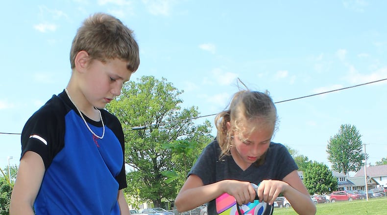 Hamilton residents and others are invited to participate in a double celebration of Earth Day and Arbor Day on Tuesday in Hamilton’s Riverside Natural Area, which is under development. Last year, these students planted a tree near their school. JEFF GUERINI/STAFF