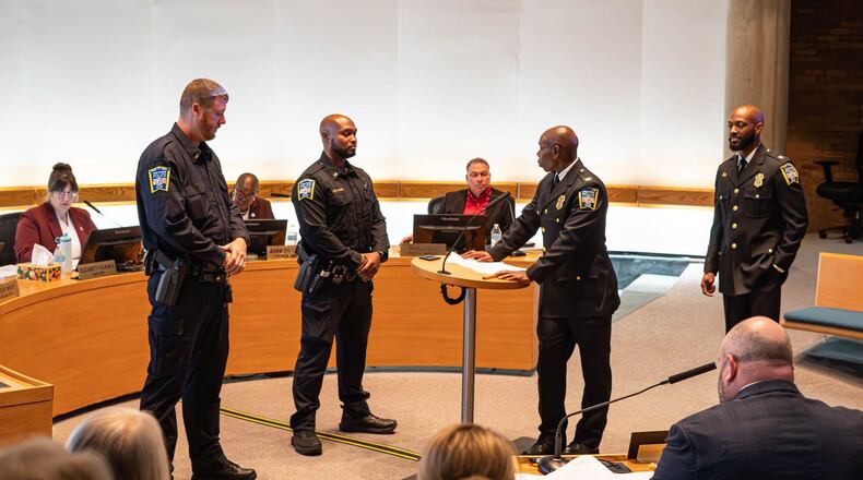 New Middletown Police Lt. Anthony Gibson (left) and Lt. Trey Porter (right) were promoted Tuesday night by Chief Earl Nelson (at the podium). CITY OF MIDDLETOWN