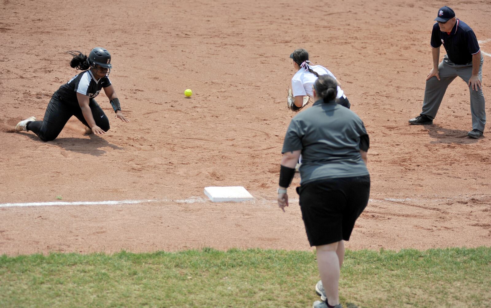 Lakota East’s Madison Cureton comes to third base as Westerville Central’s Hanna Hunt awaits the throw Friday during their Division I state softball semifinal at Firestone Stadium in Akron. East won 4-3. RICK CASSANO/STAFF