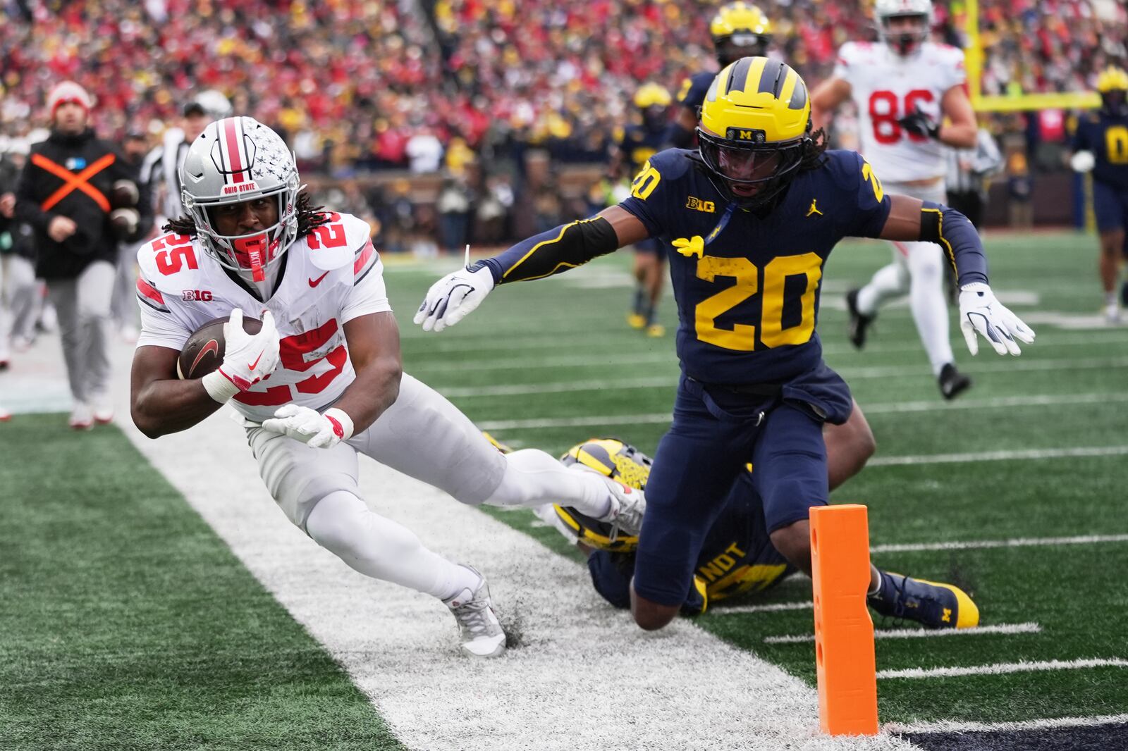 Ohio State running back Bo Jackson, left, is tackled out of bounds by Michigan defensive back Jyaire Hill during the first half of an NCAA college football game, Saturday, Nov. 29, 2025, in Ann Arbor, Mich. (AP Photo/Ryan Sun)