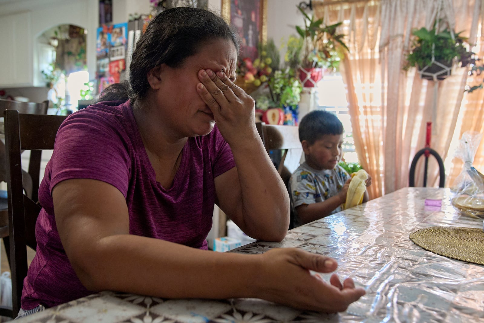 Maria sobs as she recounts how scared and anxious she is for her children, including 4-year-old Juan, if she is taken away by ICE agents, Wednesday, June 18, 2025, while inside her home in Hidalgo County, Texas. (AP Photo/Jacquelyn Martin)