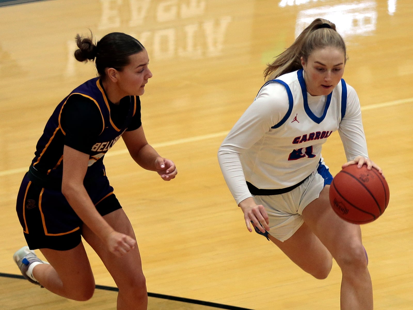 Carroll senior Kiera Healy drives against Bellbrook senior Zoe Howard. Carroll defeated Bellbrook 49-43 in a Division III regional semifinal on Tuesday, March 3, 2026, at Lakota East. STEVEN WRIGHT / STAFF