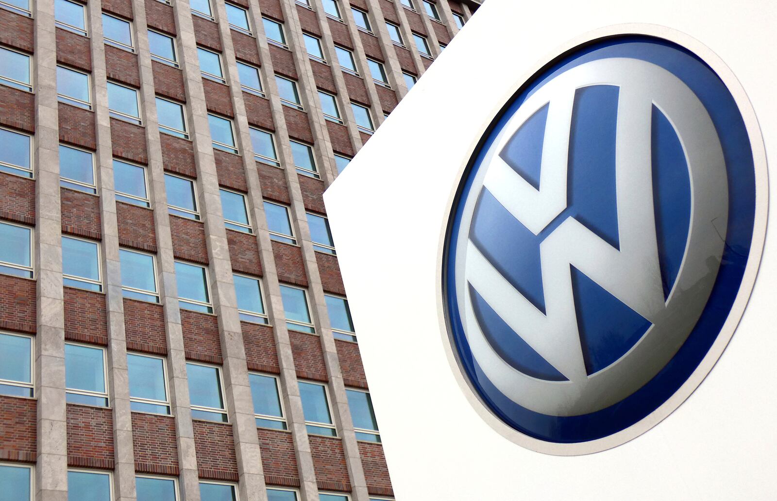 FILE - In this April 13, 2018 file photo, Volkswagen logo is pictured in front of a company building in Wolfsburg, Germany. (AP Photo/Michael Sohn, File)