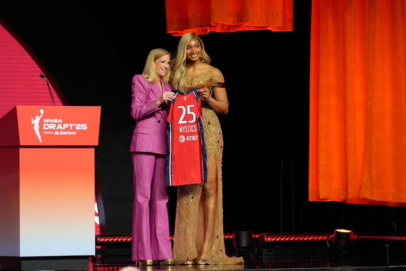 Southern California's Kiki Iriafen, right, poses with WNBA commissioner Cathy Engelbert after being selected fourth overall by the Washington Mystics during the first round of the WNBA basketball draft, Monday, April 14, 2025, in New York. (AP Photo/Pamela Smith)