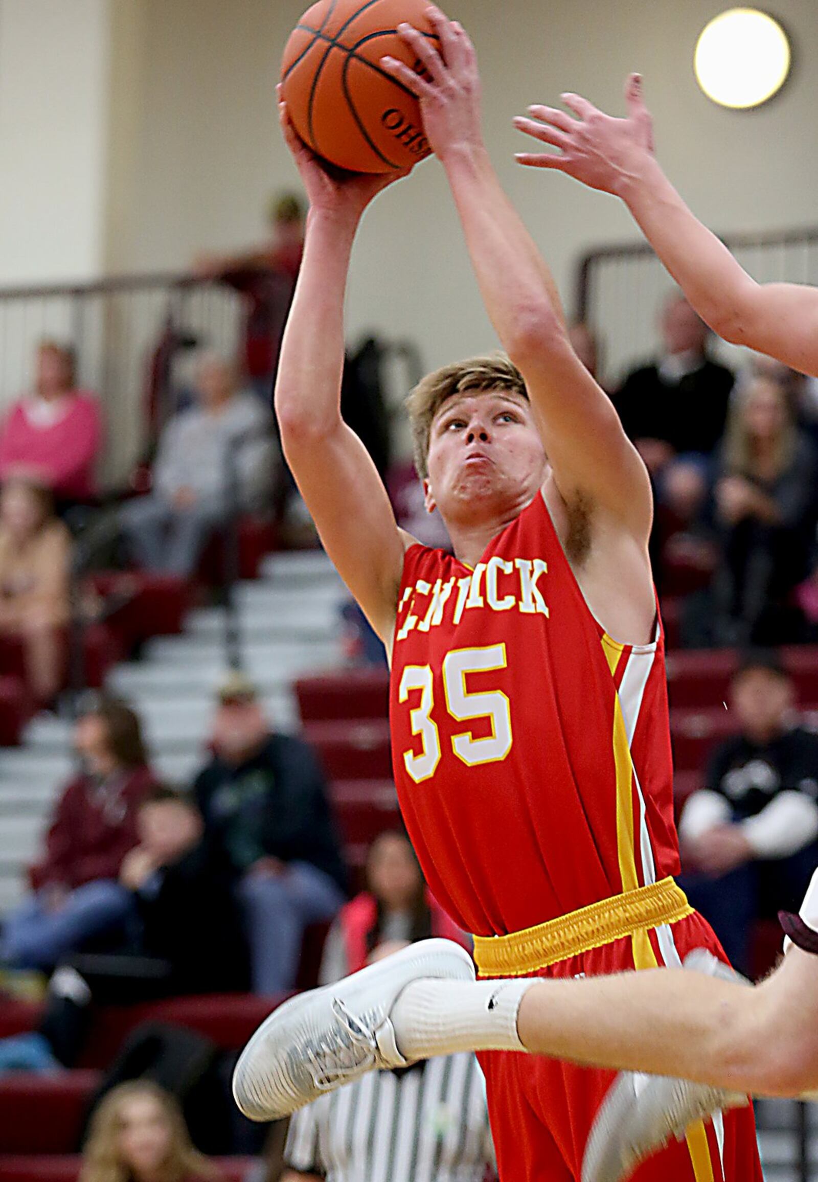Fenwick forward Luke Bradshaw scores as Lebanon guard Parker Smith flies past during their game at Lebanon on Saturday night. CONTRIBUTED PHOTO BY E.L. HUBBARD