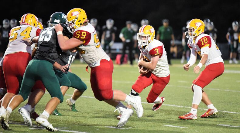 Fenwick’s Jack Fessler (3) takes a handoff from Sully Janeck and gets a block from Leo Bell (59) during a 57-26 victory over host McNicholas on Sept. 28 at Penn Station Stadium in Cincinnati. CONTRIBUTED PHOTO BY ANGIE MOHRHAUS