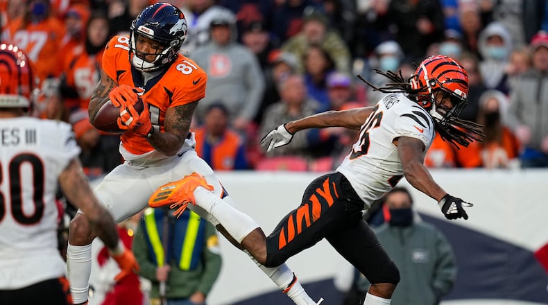 Denver Broncos wide receiver Tim Patrick (81) pulls in a touchdown pass as Cincinnati Bengals cornerback Trae Waynes defends during the second half of an NFL football game, Sunday, Dec. 19, 2021, in Denver. (AP Photo/Jack Dempsey)