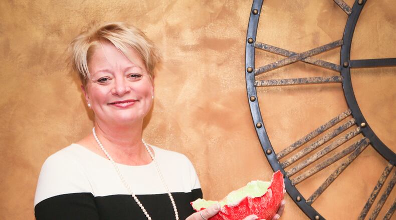 Carolyn Coley, wife of State Senator Bill Coley, with bowls made for the Empty Bowls movement.