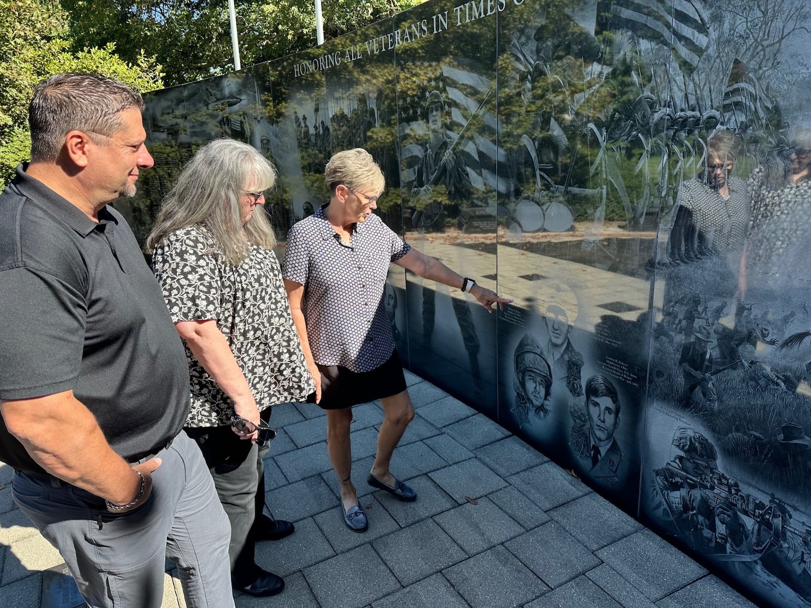 From left, Chair Neil Douglas and committee members Deb Morrison Snider and Lisa George identify three local Medal of Honor Recipients etched on the Middletown Veterans Memorial. JEFFREY DIVER/CONTRIBUTED