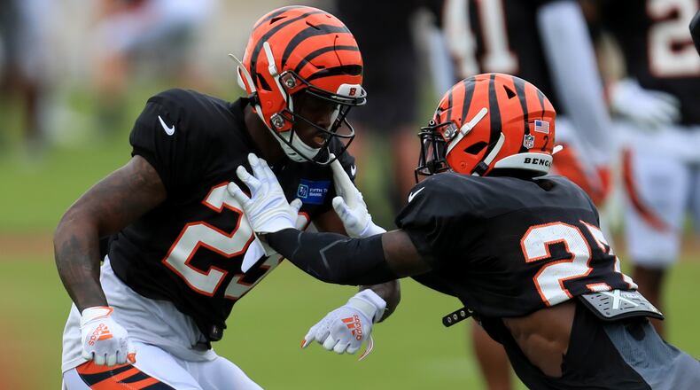 Cincinnati Bengals' Darius Phillips, left, runs a drill against Tony Brown, right, during an NFL football camp practice in Cincinnati, Tuesday, Aug. 18, 2020. (AP Photo/Aaron Doster)