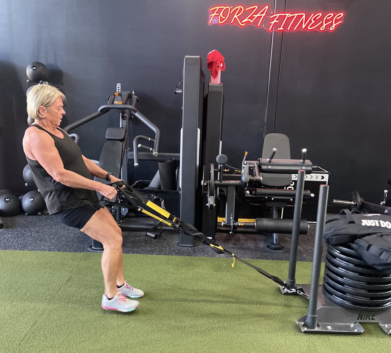 Marcy Schade pulls a weight sled stacked with 525 pounds across the fitness room floor. CONTRIBUTED